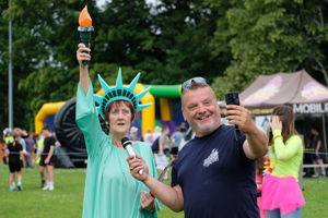 Sheila Thomas dressed as the Statue of Liberty being interview by Jungle John. Andy Compton image