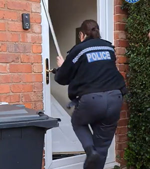 Police were seen 'bashing down' the door of the property, before finding the cannabis plants