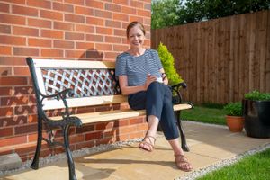 B&DWM - SGB-38604 - Cathy enjoying the sunshine in her back garden