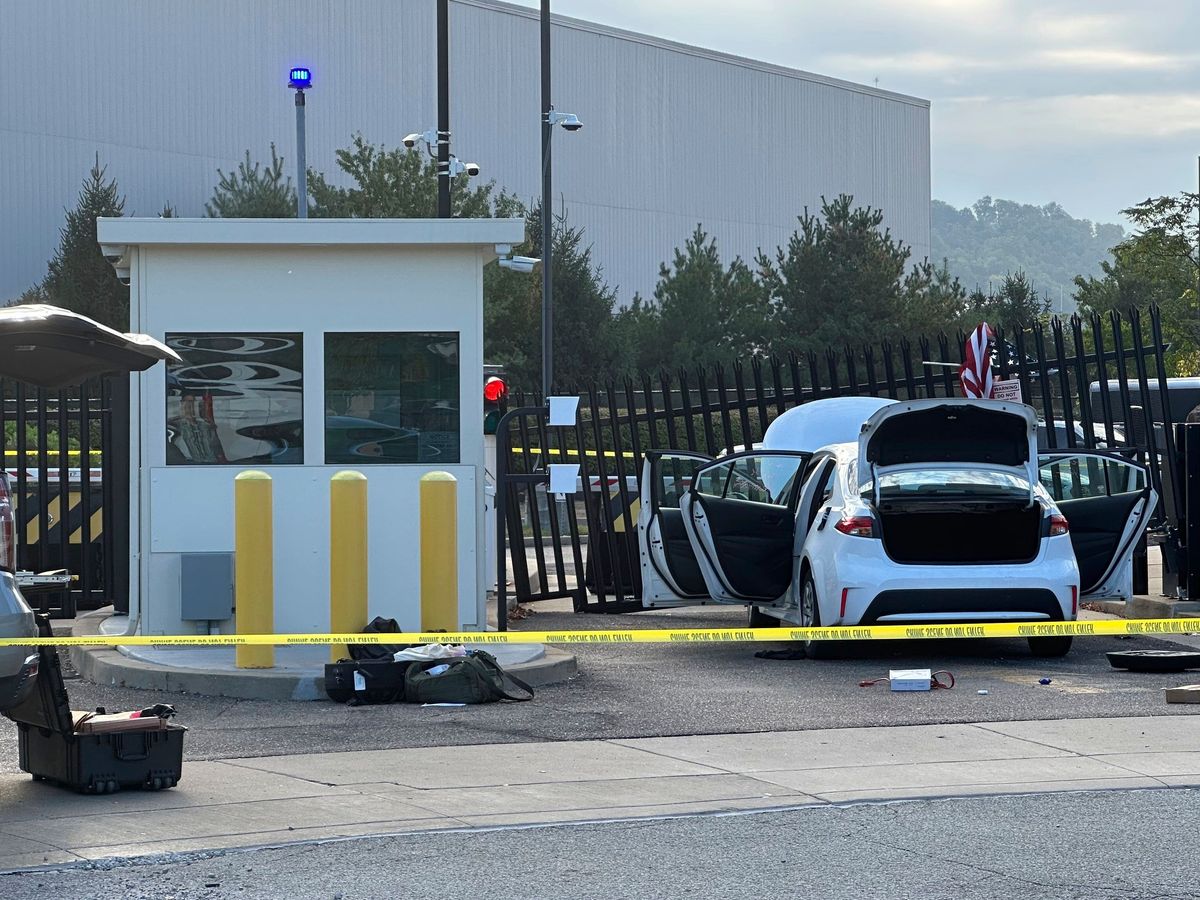 Search for driver after car rams into gate at FBI building