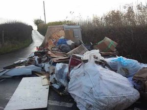 Supporting image for story: What a load of rubbish! Fly-tipper dumps boxes and breeze blocks on blind bend