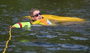 A racer keeps his cool in the river after tumbling into the water