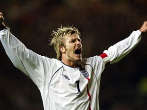 England’s David Beckham raises his arms to celebrate scoring against Macedonia