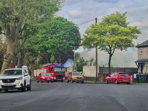 Supporting image for story: Plumes of smoke caused by a disused caravan and scaffolding board fire