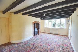 Living area in the cottage with exposed beams and a fireplace. Picture: Rightmove and Nock Deighton.