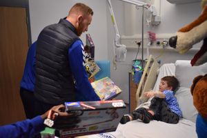 First team manager Gavin Cowan gives a present to Theo Ashley, 5.