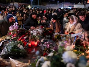 Supporting image for story: Mourners lay flowers as Swiss investigators probe fatal fire at ski resort bar