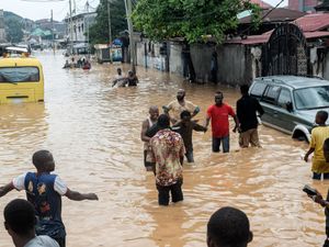 People walking through flooded streets in Kinshasa