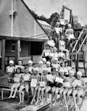 Youngsters proudly show their swimming certificates