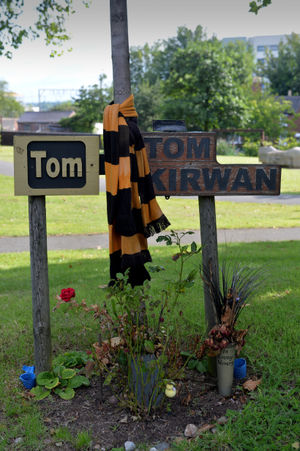 Floral tributes and Wolves shirts nearby on the ring road in memory of Tom Kirwan