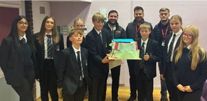 The winning Year 9 students from Mr. Adams' tutor group with their model of the building they had designed then created.