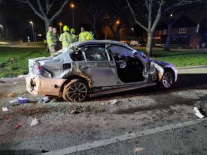 Supporting image for story: Two men cut free as car hits traffic island and rolls into parked vehicles