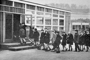 January 1966. The caption was: 'Children from the 'slum' St Mary's Bluecoat School, Bridgnorth, today moved into one of the two shining new demountable classrooms installed by Salop County Council. The school was evacuated and closed last month after an architect had condemned it as dangerous.' 