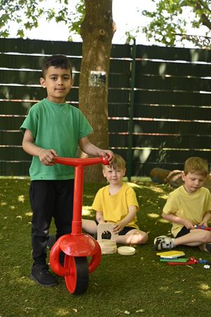 Early Years Children at Landywood Primary School enjoying new equipment funded by Landywood Stores L - R 5 years olds Imaan, Harrison and Finn.