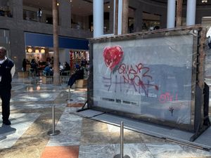 A slab of wall art, The Battle to Survive a Broken Heart, created by the artist Banksy, sits on display in New York