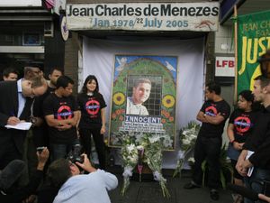 Relatives of Jean Charles de Menezes at a memorial erected outside Stockwell Tube station in south London where he was shot dead by police
