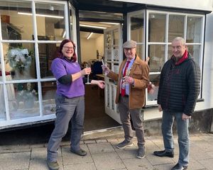 Lori with Knighton Mayor Councillor Tom Taylor cutting the ribbon to open her jewellery shop watched by Lori's husband Derek Ridgway