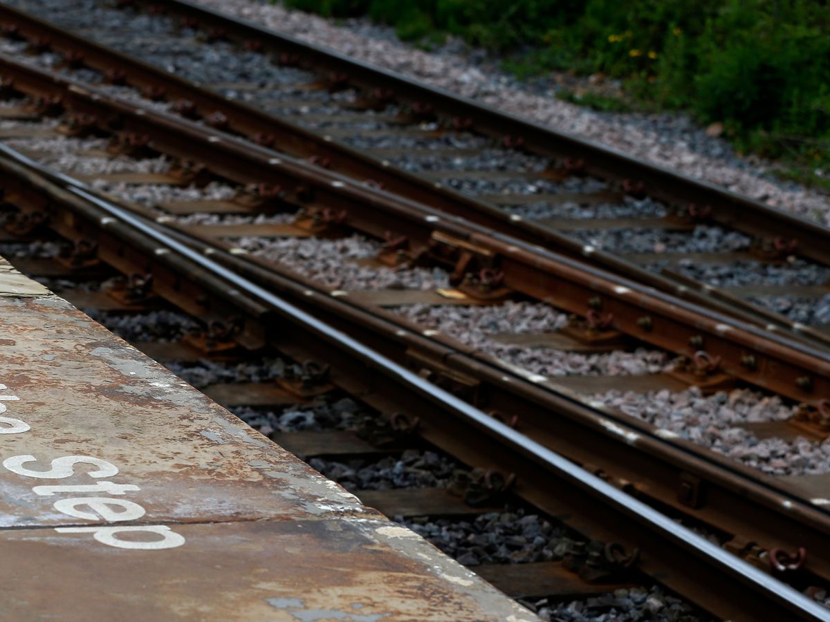 Driver in his 70s dies after car crashes on to railway track