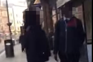 A passer-by (right) who tries to calm the situation is challenged to a fight by the woman