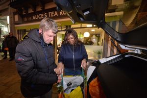 Customer Glen Hayward helps Maria set up at the cafe