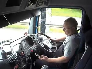 Supporting image for story: Watch: Lorry driver distracted by phone crashes into broken-down car, narrowly avoiding three people