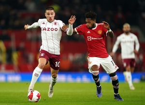 Aston Villa's Emiliano Buendia (left) and Manchester United's Fred battle for the ball (PA)