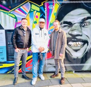 Goldie (middle) with Joe Nixon (left) and Josh Smith from Arts Creative who deliver the Street Stories project in front of the artwork