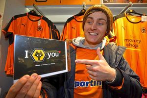 Josh Bowater, 21, from Great Wyrley, clutches a Valentine's card on sale at the Wolves shop