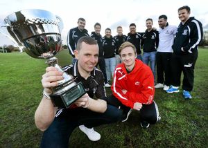 Owen Richards presents the prize to captain James McGlynn, and back left to right: Pete McLoughlin, Dan Foley, Ryan Blanchette, Kieran Walpole, Nick Dalton, John O'Flynn, Ciaran Murphy, and Bryan McDaid