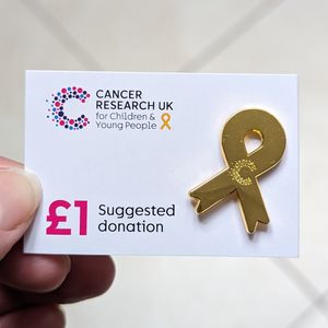 People can buy gold ribbon badges from Cancer Research UK shops in Wolverhampton, Staffordshire and the Black Country to support research into children's cancers.