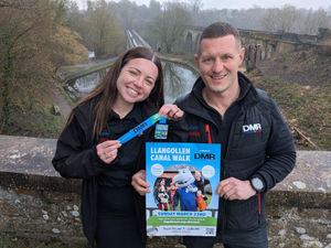 Rosie-Jane Quayle and Daniel Roth, directors at DMR Plumbing & Heating, who are sponsoring this year's Llangollen Canal Walk show off the medals created for the event.