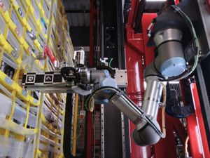 A robotic arm picking up items in a warehouse
