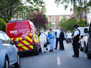 Forensics officers are seen investigating the fire at Sir Keir Starmer's former home in Kentish Town