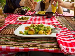 A group of people sharing a meal at a casual outdoor table