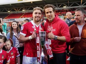 Wrexham co-owner Ryan Reynolds (centre right) with player Sam Smith