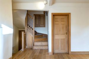The wooden-floor landing with a winding staircase.