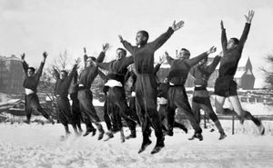 Shrewsbury Town players in training in the snow on New Year's Day in 1962. The caption reads: 'The 'ups and downs' of the football world, depicted by the Shrewsbury Town players as they limbered up in preparation for their cup match at Southport.'