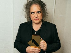 The Cure’s Robert Smith with the band’s Official Charts number one album award (Tom Pallant/PA)
