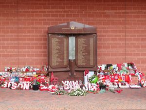 Flowers and tributes left at the Hillsborough Memorial outside Anfield stadium in Liverpool