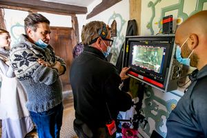 Director Simon Hunter examines a scene during filming at Upton Cressett