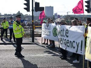 Supporting image for story: Extinction Rebellion protesters hold up Birmingham commuters