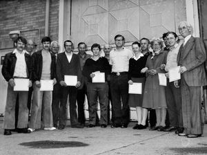A presentation of awards to Donnington depot transport drivers. They include, fifth from right, (between two women), Gvoka or Govaka; middle, between the man with glasses and a woman, Knezevic; and on the other side of the same woman, Karpenko.
