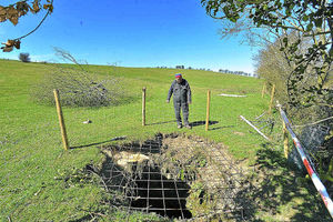 Farmer Phil Keal looks at the scene of the rescue after a lamb fell down a well at Shepherds Whym Farm near Bishops Castle