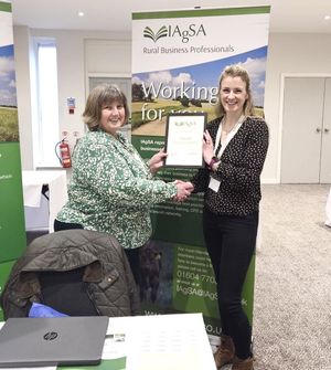 Clarrie collects her award 