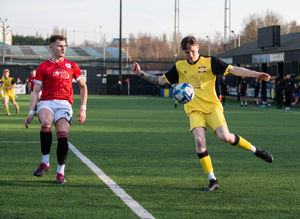 A Dudley Town player, left, closes down a Whitchurch crossing opportunity.  Pic: Liam Pritchard