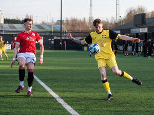 A Dudley Town player, left, closes down a Whitchurch crossing opportunity.  Pic: Liam Pritchard