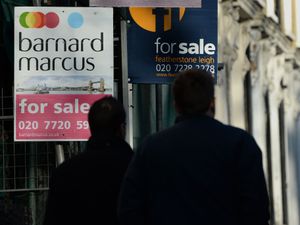 People look at estate agents' boards