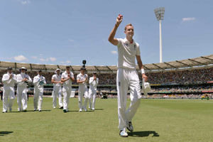 England's Stuart Broad holds the match ball as England leave the filed after he took six wickets