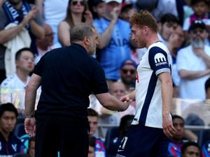 Tottenham manager Ange Postecoglou (left) speaks with Dejan Kulusevski following being taken off after receiving treatment