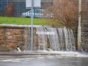 Supporting image for story: Oswestry flooding fears as water bursts from manhole - and flooded lines halt trains